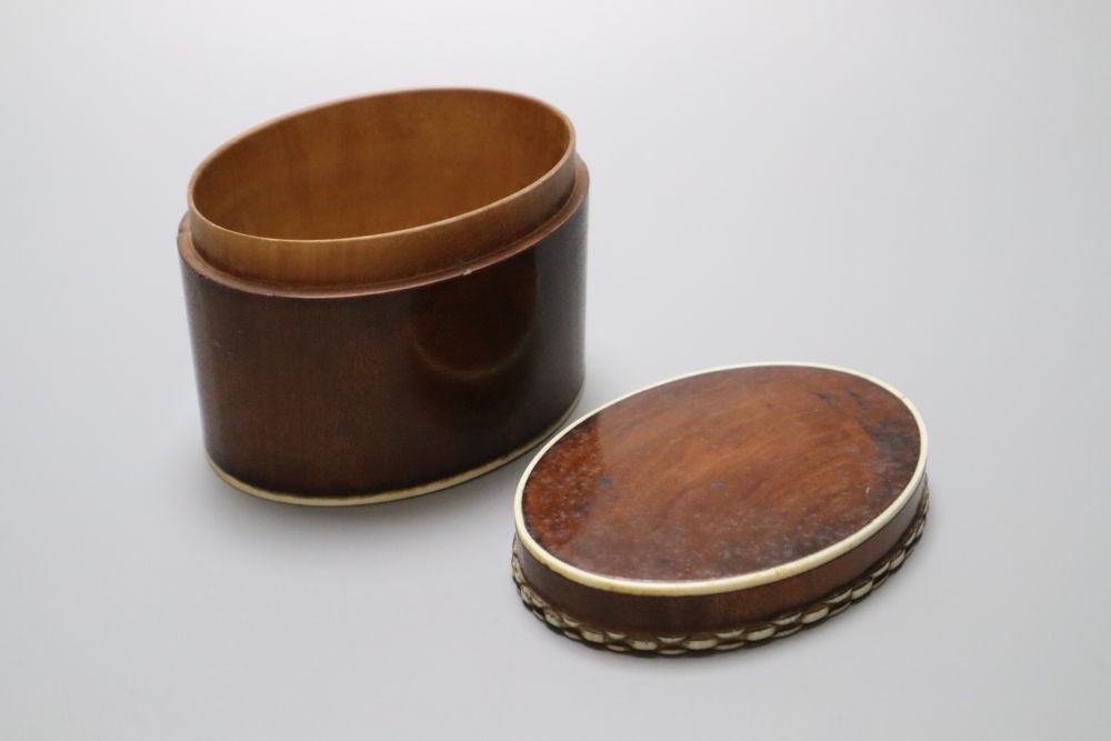 A 19th century lignum vitae turret shaped jar and cover, a similar acorn shaped string box and bowl, and a stained sycamore and engine